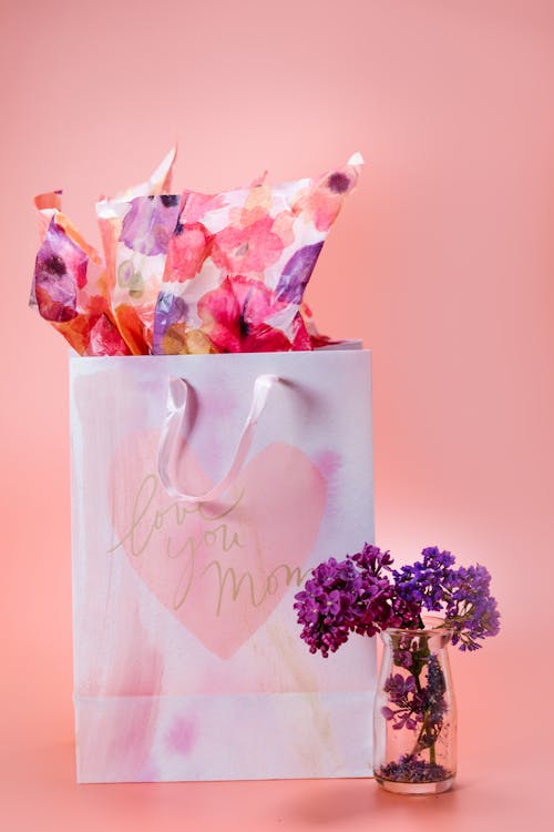 Purple Flowers on Glass Vase and a Paper Bag 