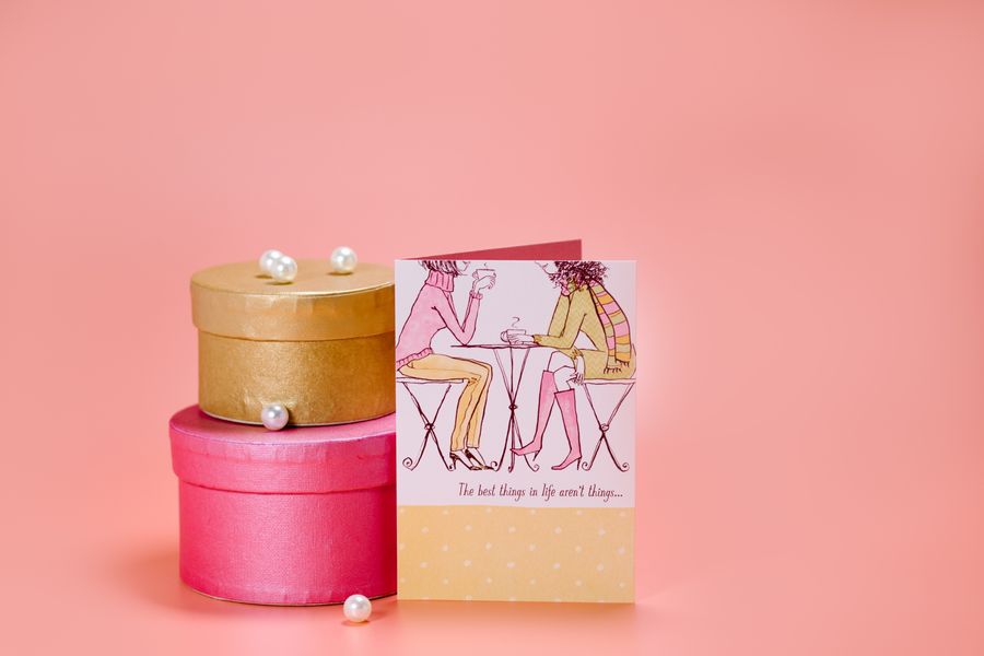 Stacked gift boxes with a greeting card resting against them