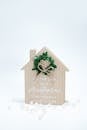 Wooden House with Leafy Wreath