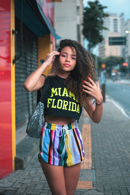 Woman in Crop Top Standing on the Sidewalk