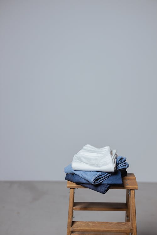 Folded Pants on Wooden Stool