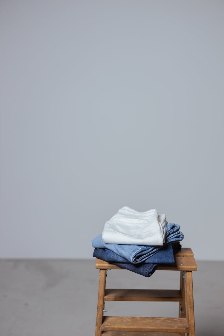 Folded Pants On Wooden Stool