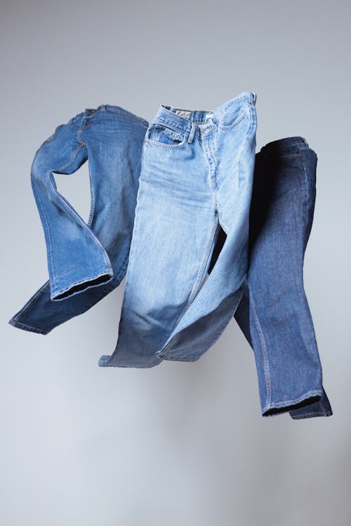 Free Blue Denim Jeans on White Table Stock Photo
