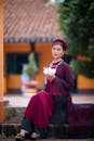 A Beautiful Woman in Traditional Clothing Holding a White Flower