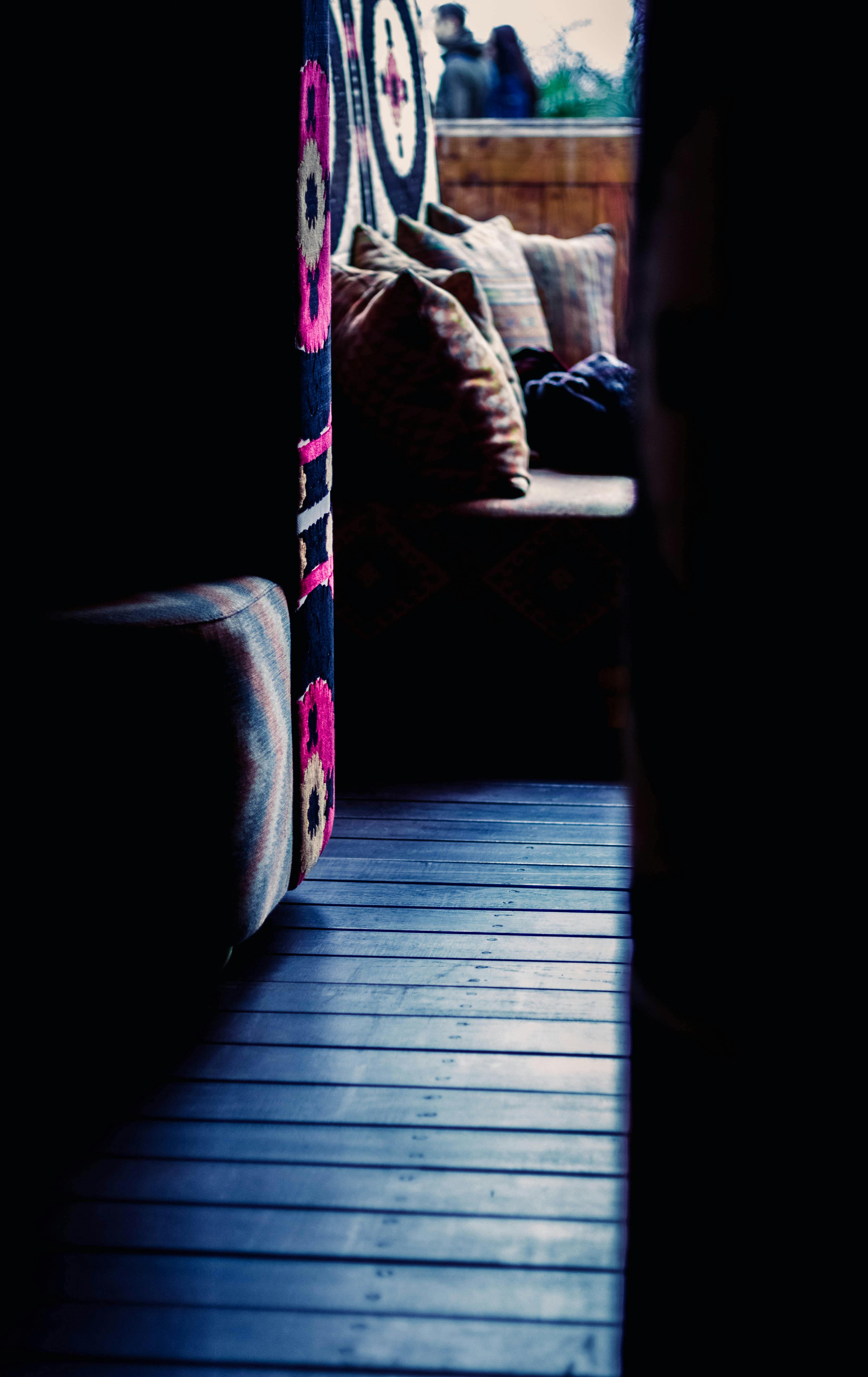 Free Warm indoor space with colorful throw pillows and sunlight filtering through. Stock Photo