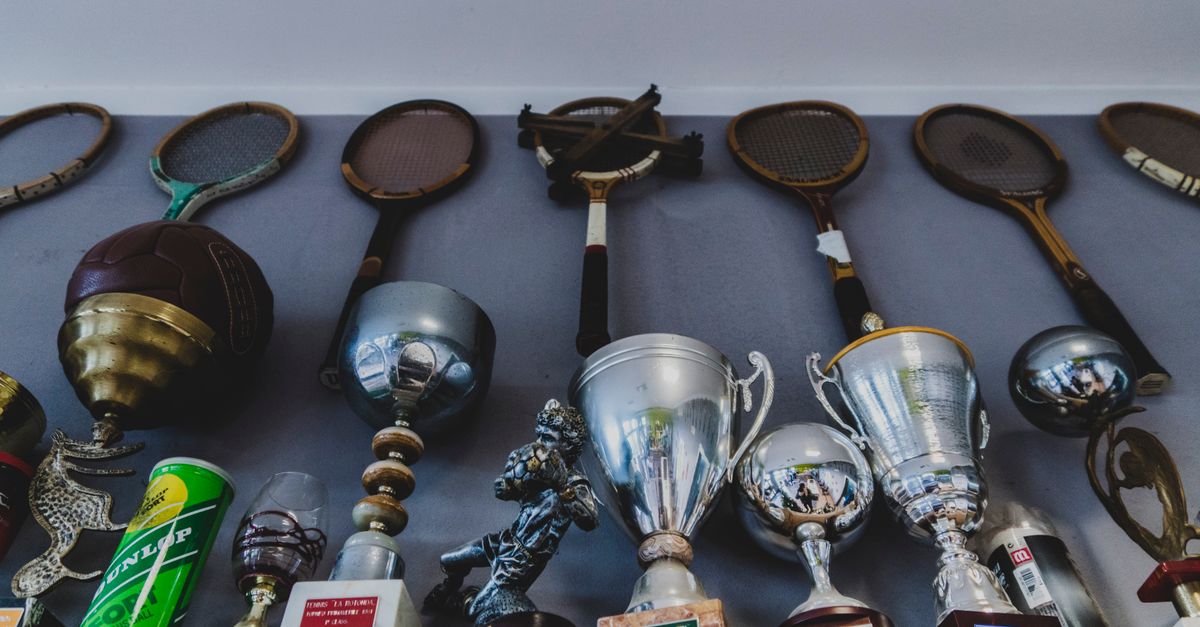 vintage sports memorabilia collection displayed on wooden shelves with warm lighting