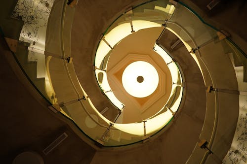 Spiral Yellow Staircase with Chandelier on Top