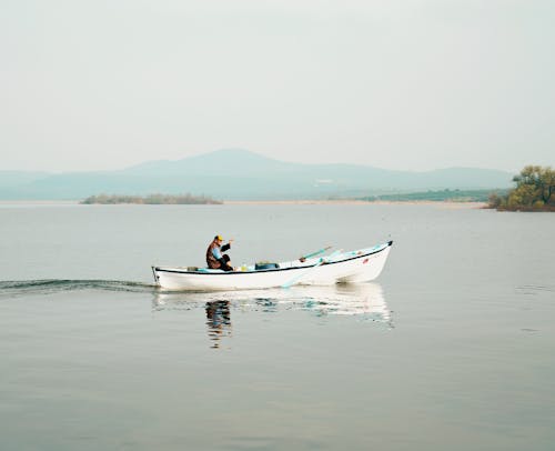 Man Riding a Motorboat at the Lake