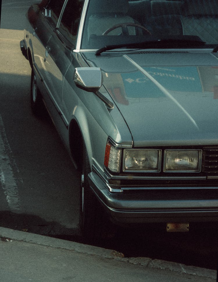 A Car On A Parking Space Beside A Curb