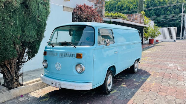 Classic blue Volkswagen van parked on a sunny day in Morelia, Mexico, showcasing retro charm.