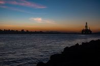Silhouette of Rocks on Sea during Sunset
