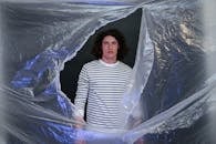 Man through Hole in Plastic Foil