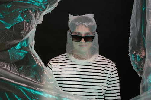 A Person Covered in Plastic Wearing Sunglasses