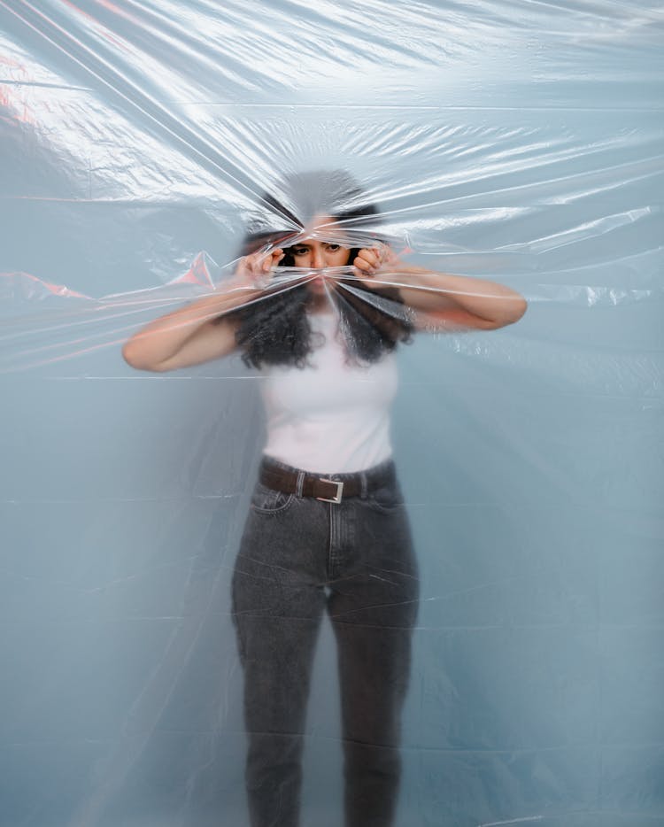 A Woman Tearing A Plastic