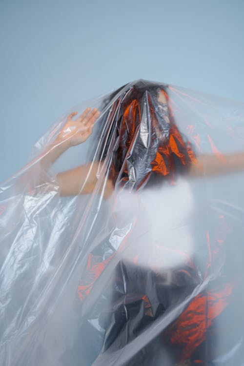 A Person Standing Behind a Plastic Sheet