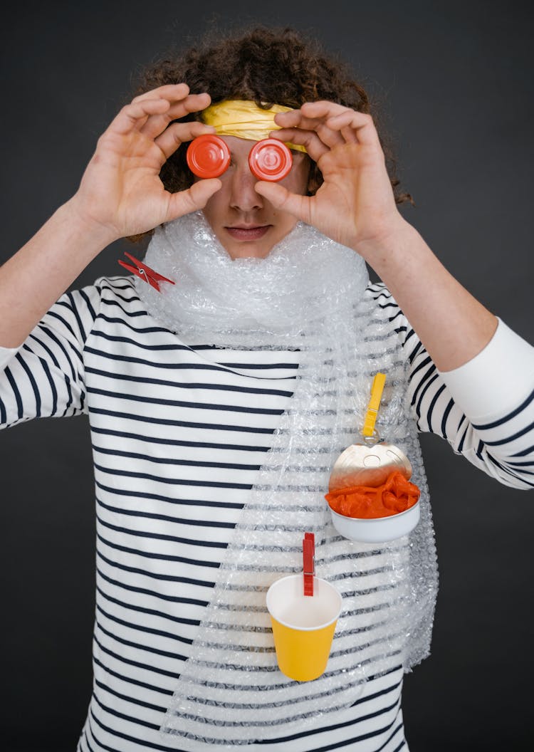 Person Looking Through Bottle Caps