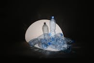 A Spotlight Cast on Plastic Bottles on Black Background