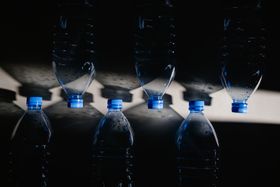 Row of unlabelled clear water bottles — photo by MART PRODUCTION on Pexels
