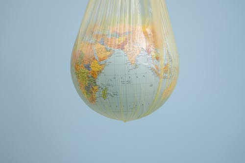 Plastic Globe Hanging Inside of a Paper Bag