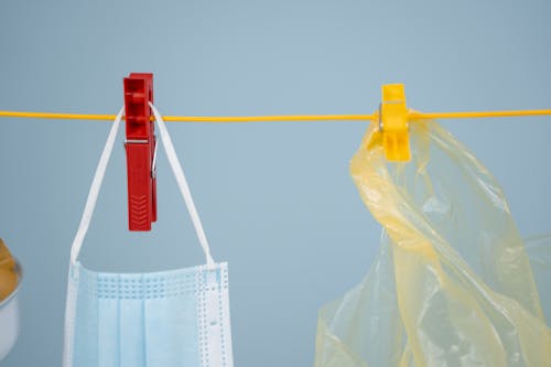 Free A Plastic and a Face Mask Hanging on a Clothes Line Stock Photo