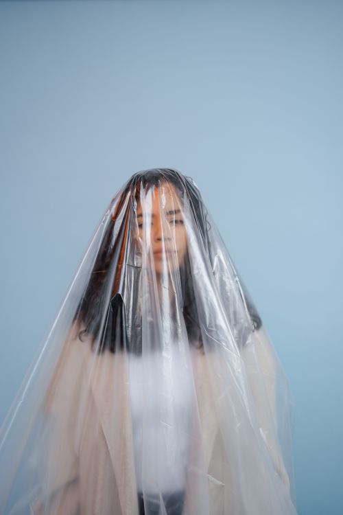 Free Artistic portrait of a woman covered in plastic, highlighting environmental themes. Stock Photo