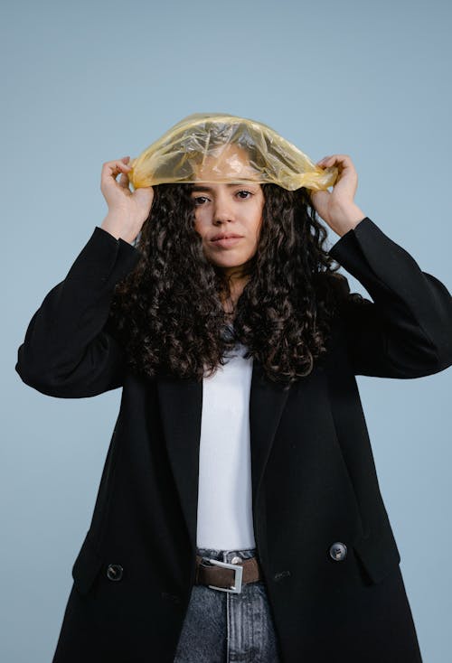 Free A Woman Covering Her Head with a Plastic Bag Stock Photo