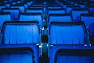 体育场外，蓝色塑料座椅空置的特写镜头