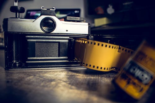 Black and Gray Camera With Yellow Film