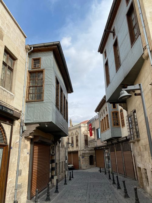 Free A scenic view of a narrow alley with traditional Ottoman architecture and a clear sky. Stock Photo