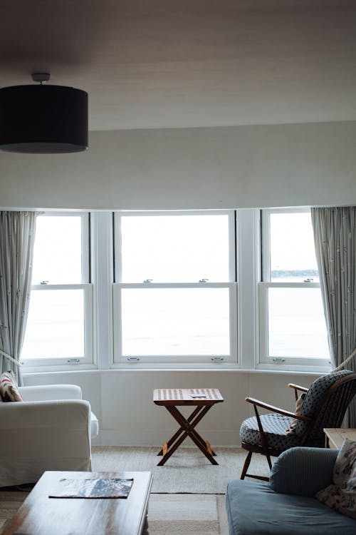 Two Chairs Facing Towards White Casement Window