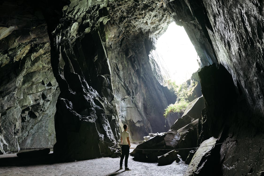 Person Standing Inside Cave