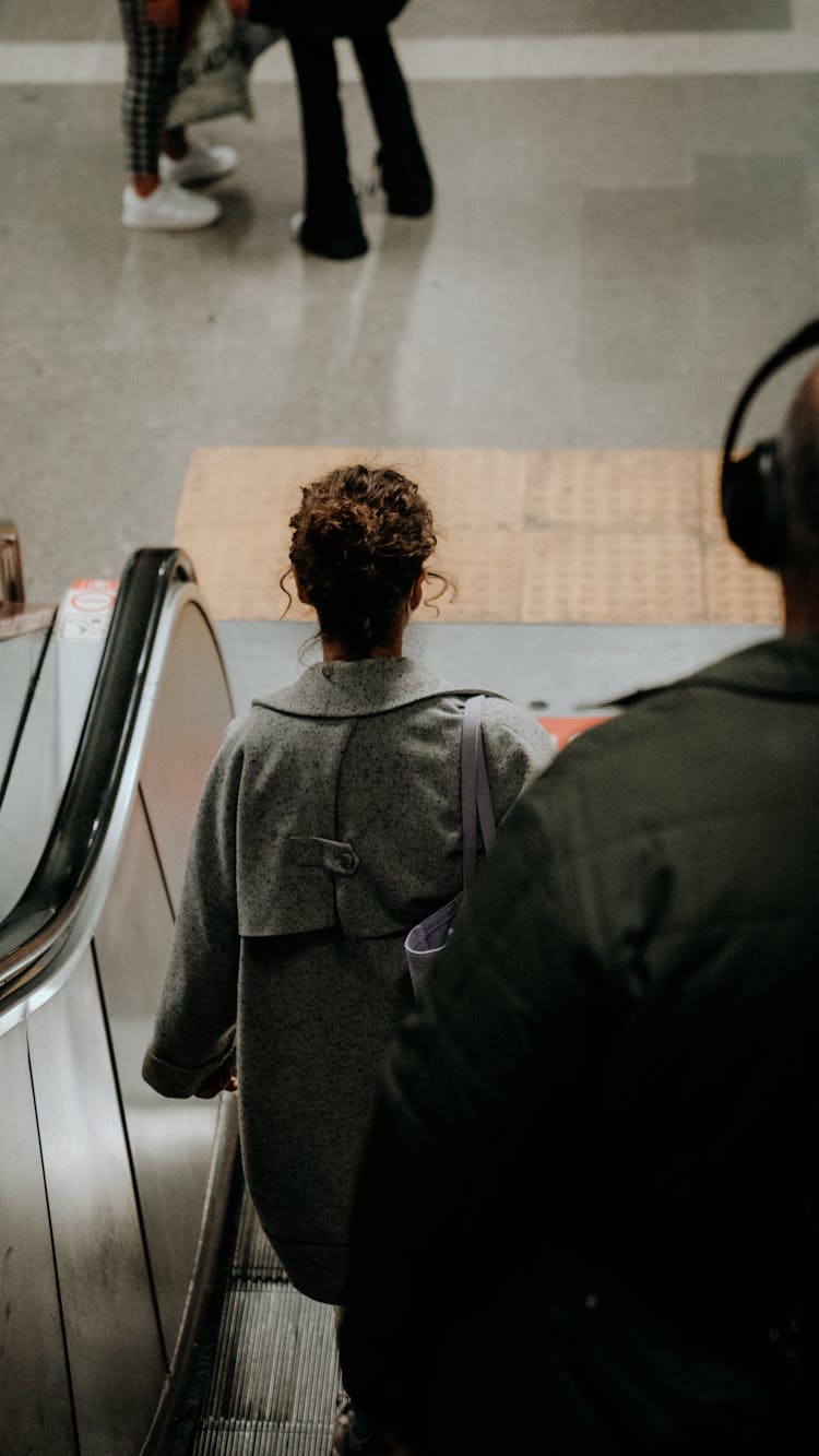 Travelers On The Escalator Of The Subway Station