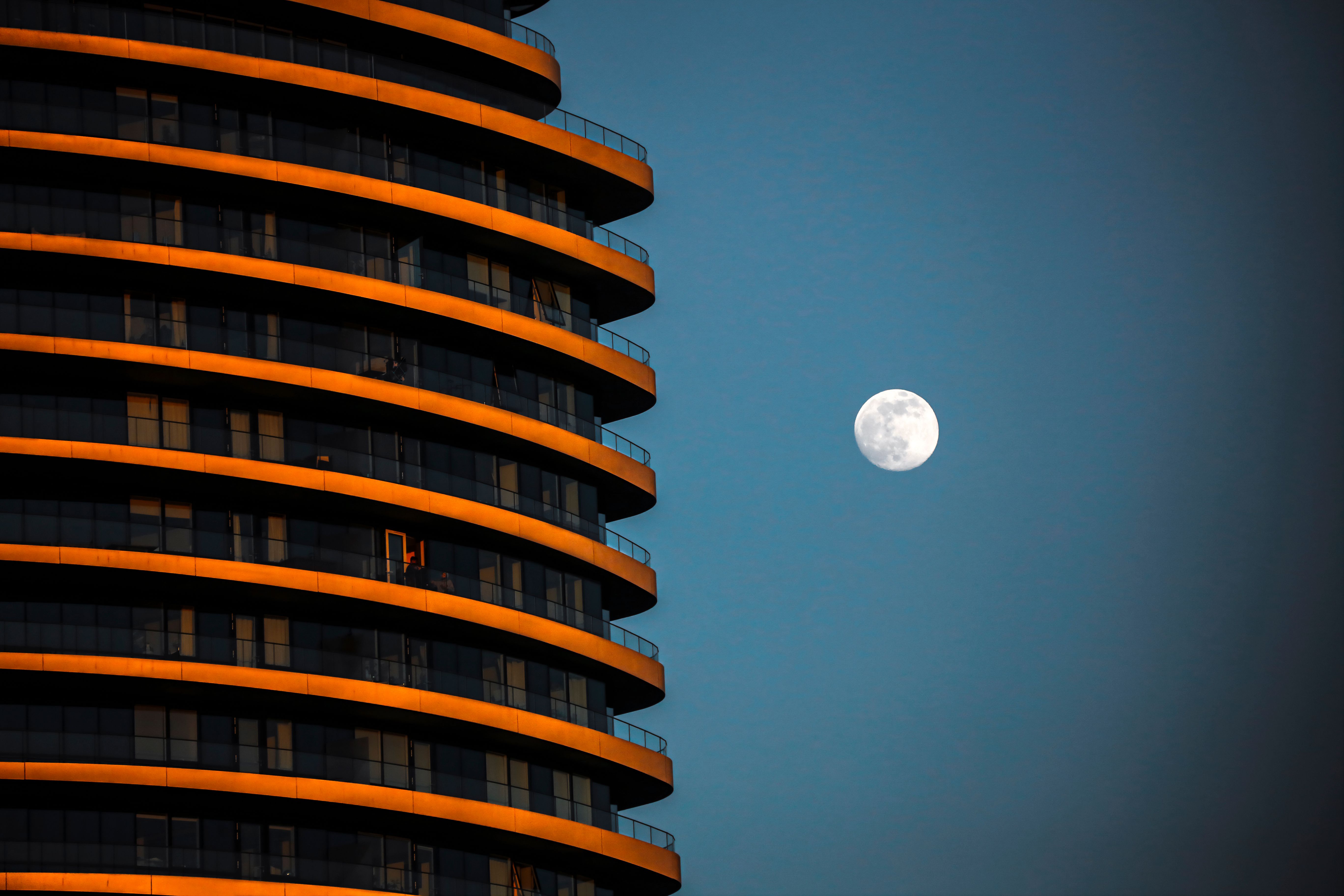 A Building and a Moon Across the Blue Sky · Free Stock Photo