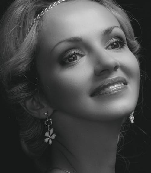 Monochrome Photo of a Beautiful Woman with Earrings Smiling
