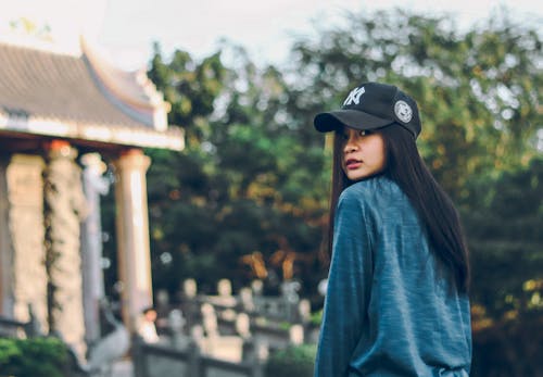 Woman Wearing Sweater And Baseball Cap