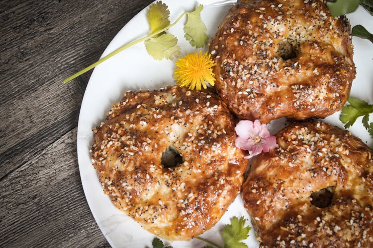 Bagels In Plate With Flowers And Coriander Garnish