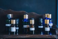 Black Glass Bottles on Brown Wooden Shelf