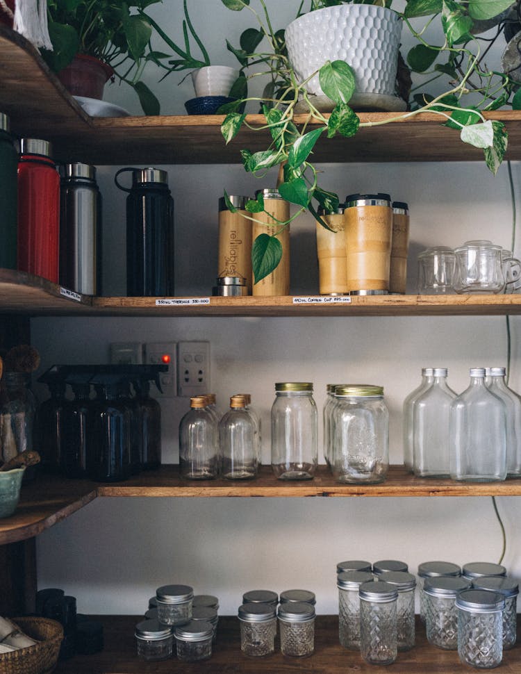 Glass Bottles And Containers On A Wooden Shelf