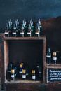 Bottles in Brown Wooden Shelf