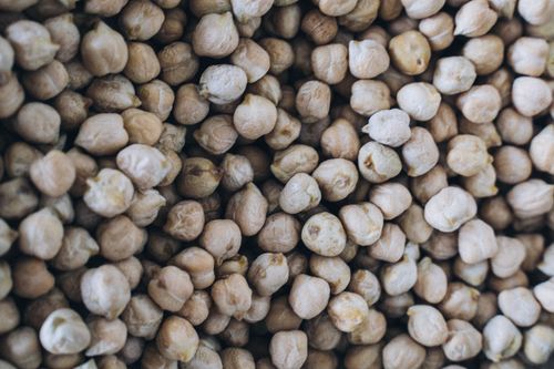 Free Detailed texture view of organic chickpeas, highlighting natural abundance and nutrition. Stock Photo