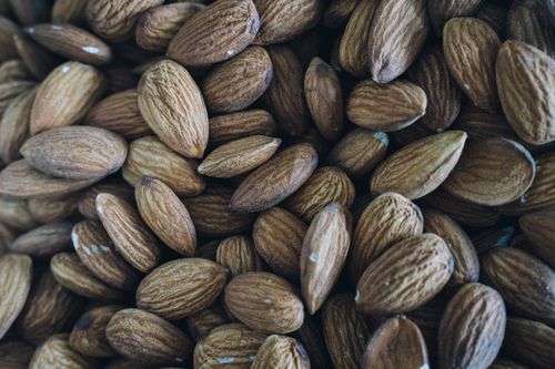 Free A detailed close-up of raw organic almonds showcasing texture and health benefits. Stock Photo