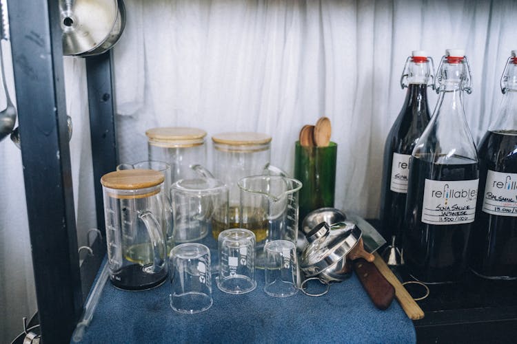 Glass Measuring Cups Drying Next To Bottles Of Organic Products