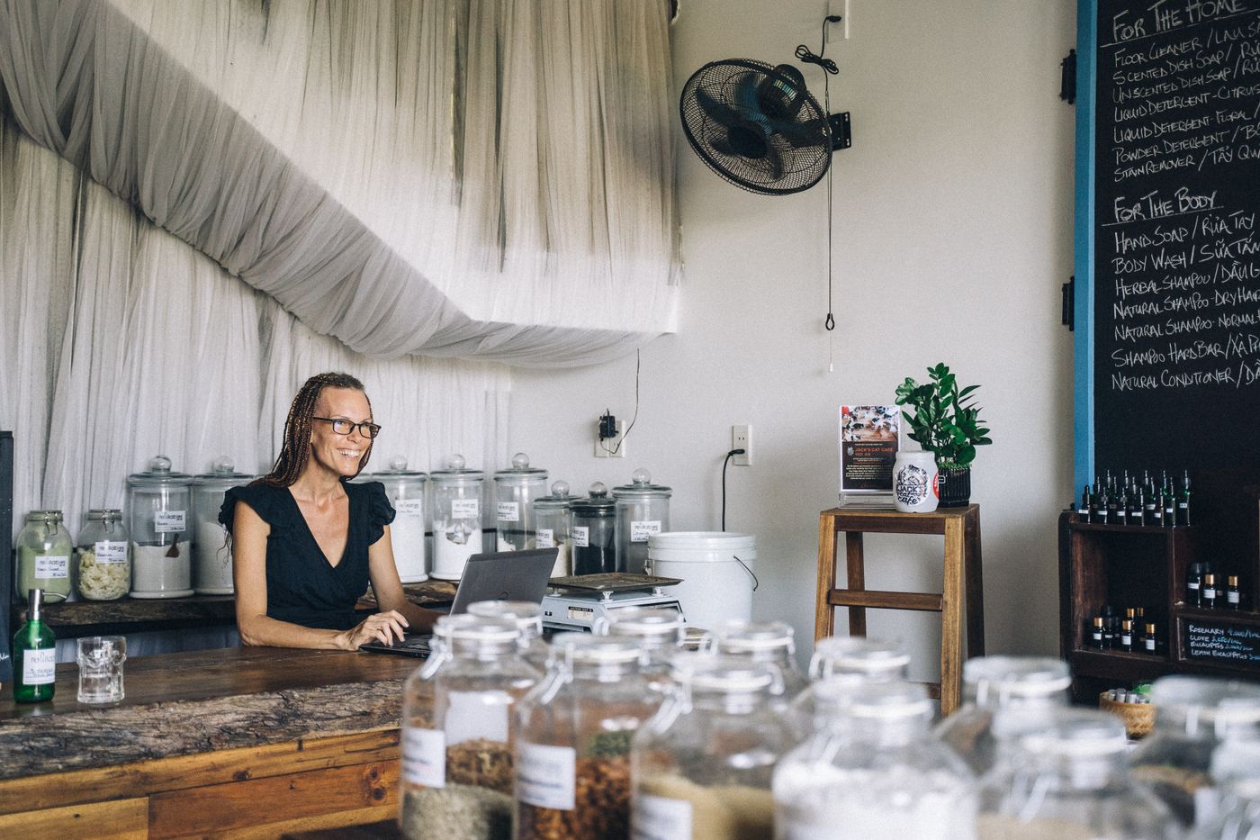 Small business owner working on a laptop in her shop