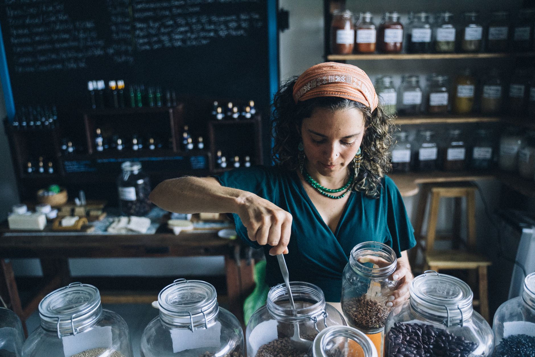 Woman Taking Seeds Out From a Jar with a Spoon