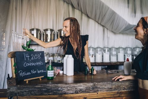 Free Eco-friendly store with staff refilling containers, promoting sustainable shopping. Stock Photo