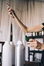 Person Holding Cylindrical Glass Tubes