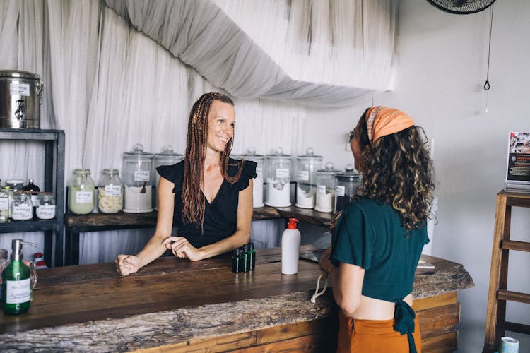 A Woman Smiling At A Customer