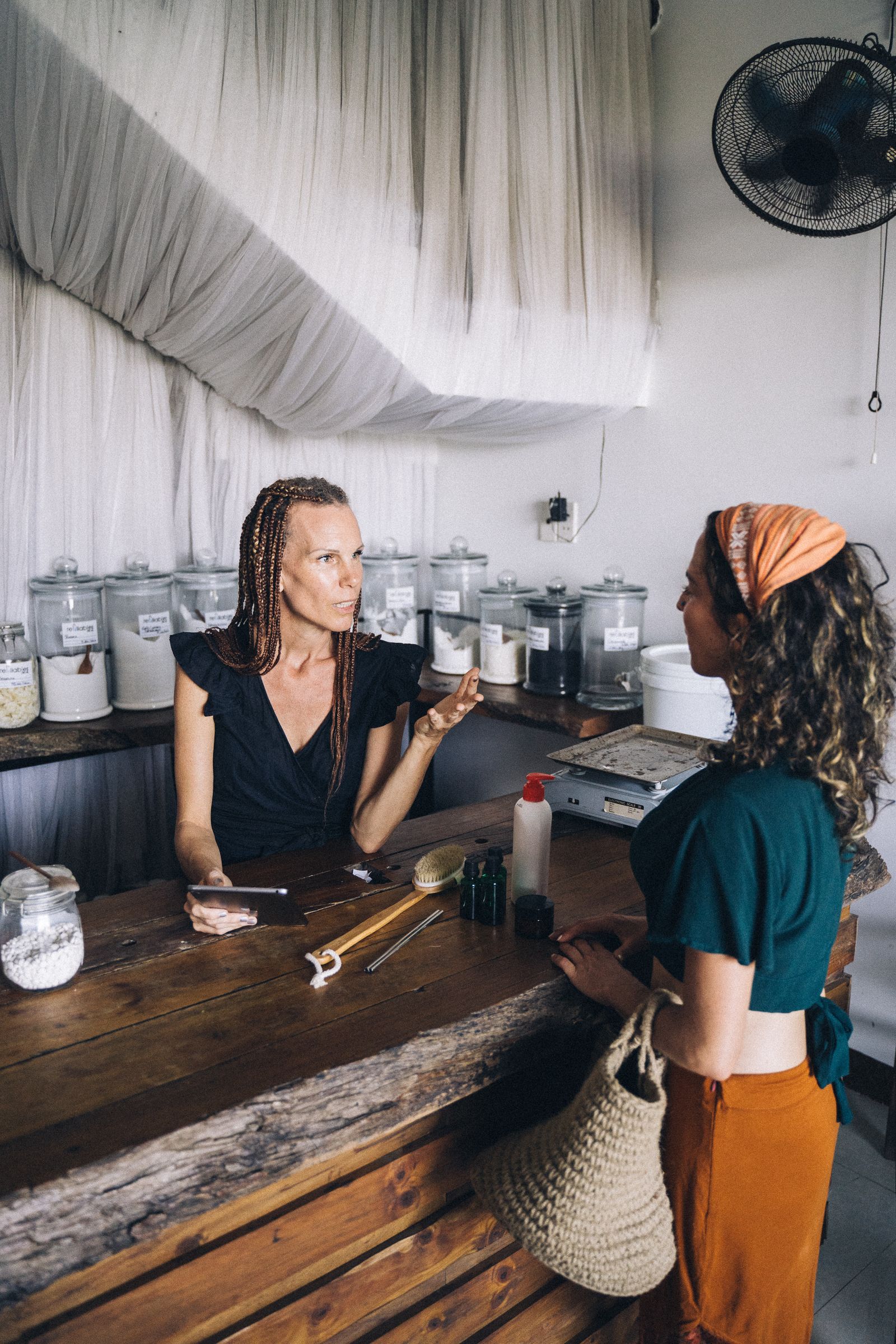 Customer and shop assistant discussing an issue in a local store