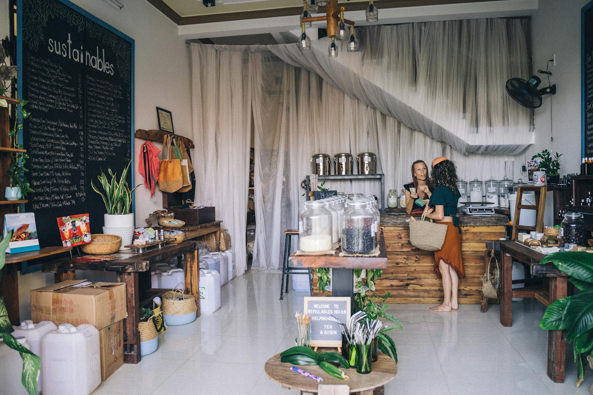 A cozy eco-friendly store with sustainable goods and two people interacting.