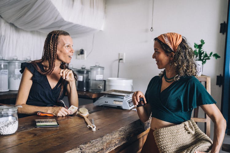 A Customer Talking To A Woman At The Counter